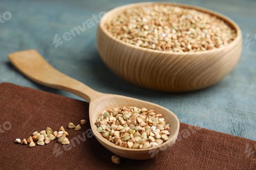 Preview: Uncooked green buckwheat grains on table, closeup