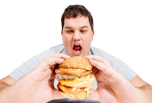 Preview: Get in my belly, burger. An obese young man about to eat a huge hamburger.