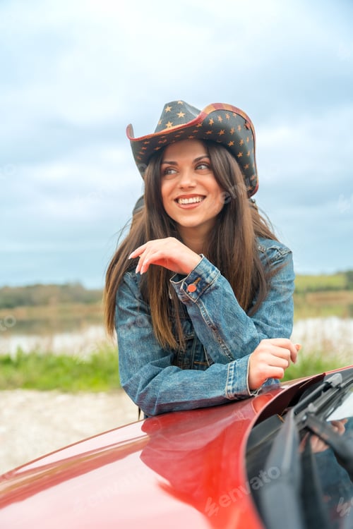 Preview: Woman with cowboy hat leaning on a car