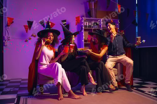 Preview: Asian friends, middle-aged man and young woman, enjoy Halloween office party with vampire costumes