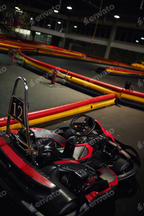 Preview: design of red racing car inside of indoor kart circuit, motor race vehicle with number twelve