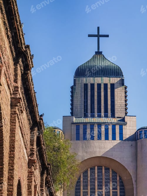 Preview: the large building with a cross on top of it's steeple