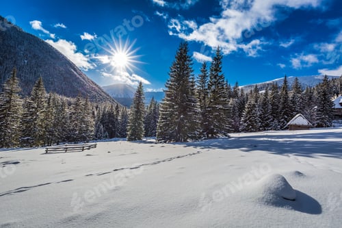 Preview: Small wooden cabin covered by snow in winter at sunrise, Tatras, Poland