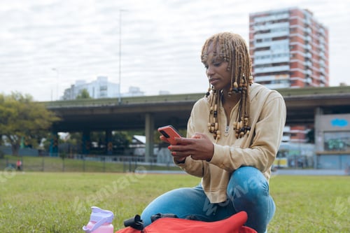 Preview: Close-up of young woman texting on sports field before warm-up