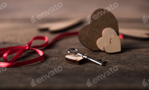 Preview: Little red heart shape on dark wooden background. Saint valentines, love greeting card and invitatio