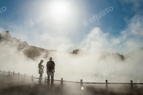Preview: Two people in rising mist at a thermal pool site
