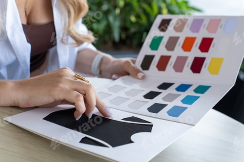 Preview: Woman Designer Choosing Concentrating on Visual Design in Modern Outdoor Workspace