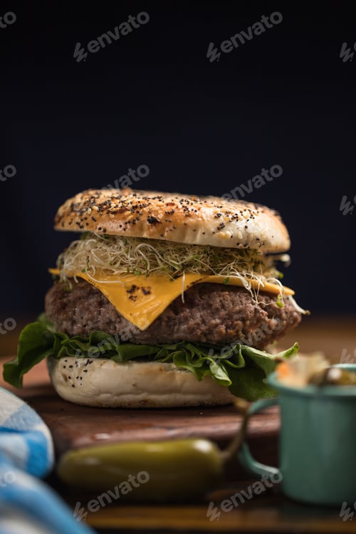 Preview: Sandwich of cheese burger with lettuce on black background