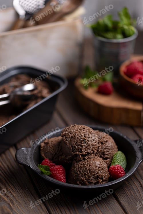Preview: Homemade chocolate ice cream balls with raspberries and mint