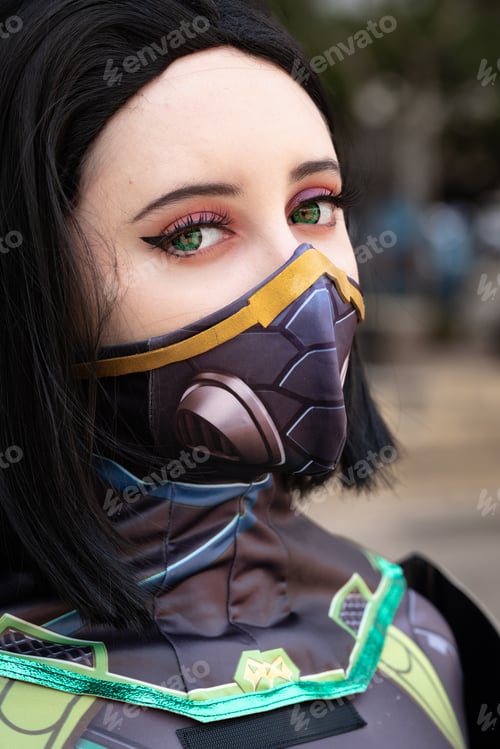 Preview: Closeup portrait of a female cosplayer in a green action suit