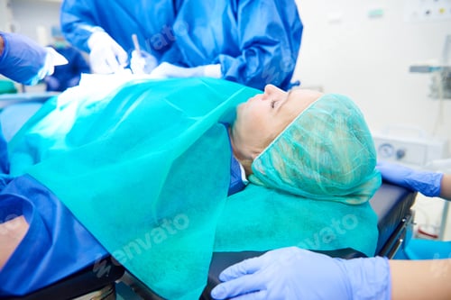 Preview: Woman being operated by surgeons