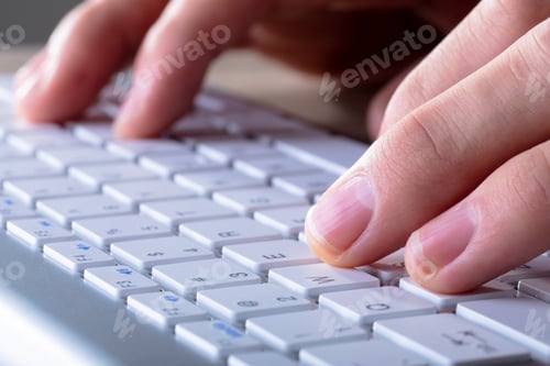 Preview: Close up of caucasian businessman typing on keyboard, isolated on grey background