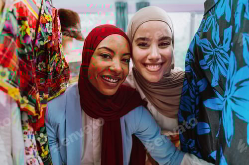 Preview: women friends smiling shopping in clothing store