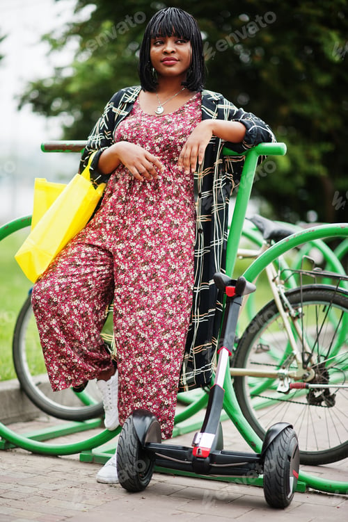 Preview: African american woman using segway or hoverboard