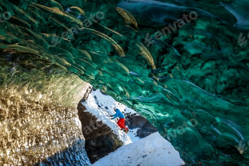 Preview: Person exploring a glacial Ice Cave on the Svinafellsjokull glacier