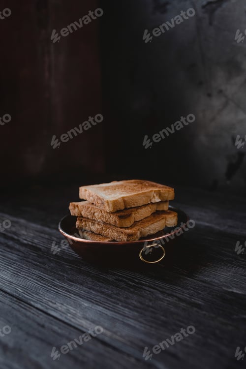 Preview: close up view of toasts on plate on wooden tabletop