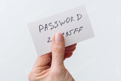 Preview: Woman's hand holds a password on paper, that covers the password with finger
