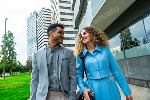 Preview: Business couple walking together smiling in city