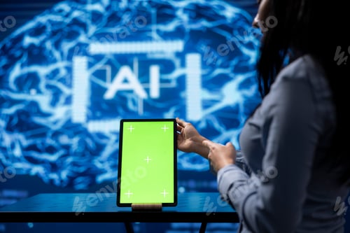 Preview: Startup coworkers brainstorming ways to use AI, using mockup tablet