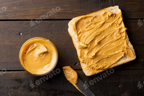 Preview: Image of bowl and bread slice with peanut butter on wooden surface