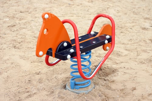 Preview: Rocking horse in sandy playground outdoors