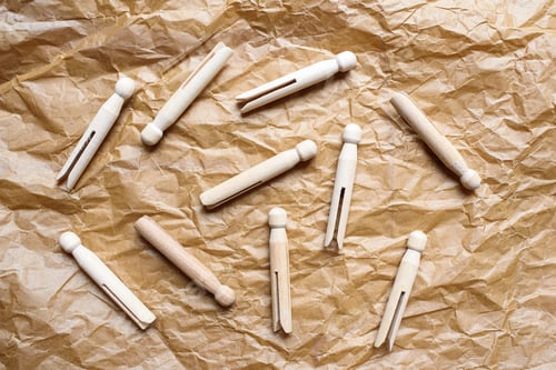 Preview: Wooden clothespins for hanging clothes on crumpled packing paper.