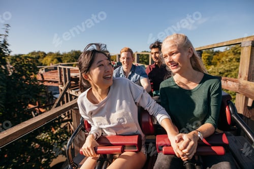 Preview: Young friends riding roller coaster