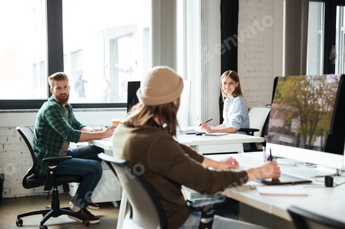 Preview: Colleagues work in office using computers. Looking aside.