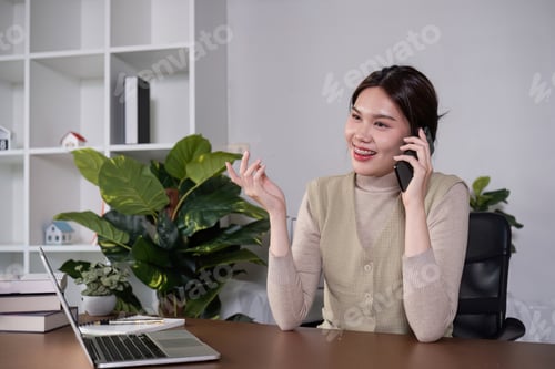 Preview: Asian college student sit at home studying online using a video calling program on their laptop.