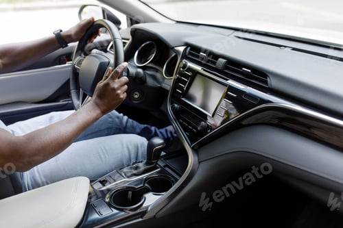 Preview: Closeup of black man hands driving luxury car