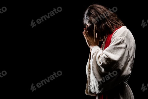 Preview: religious man covering face while praying isolated on black