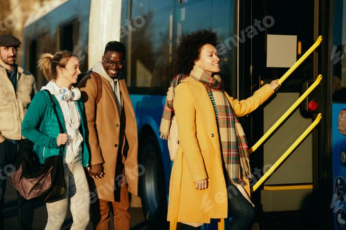 Preview: Group of happy people entering a bus at the station.