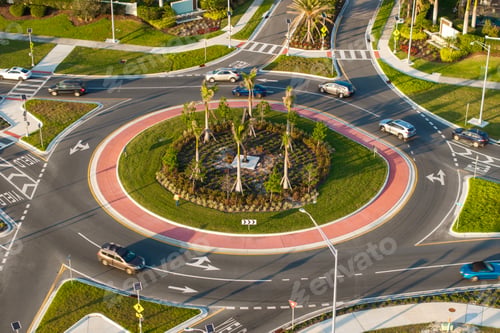 Preview: Roundabout crossroads on American city street with moving traffic cars.
