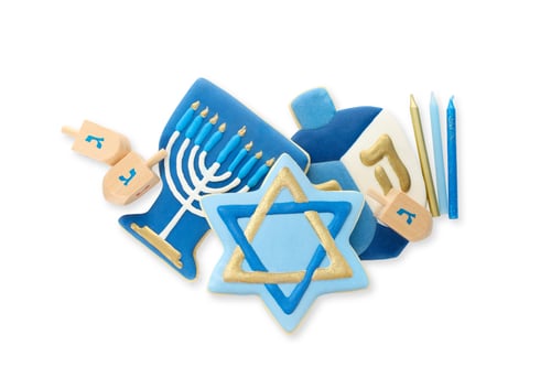 Preview: Hanukkah cookies shaped as menorah, dreidels, and stars, on white