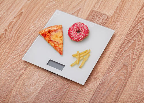 Preview: Diet. The concept of junk food on weight. Healthy Lifestyle. Wooden background.