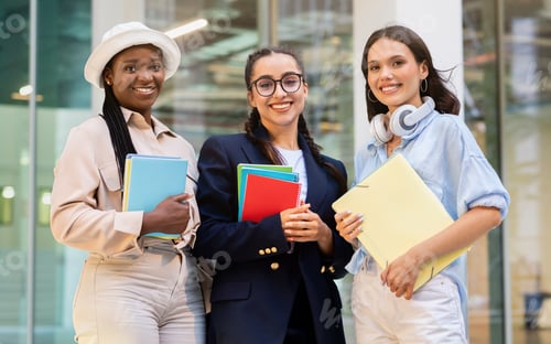 Preview: Multiracial group of students three ladies posing at campus
