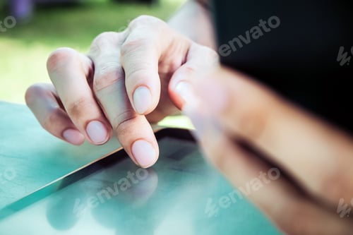 Preview: image of hand using digital tablet close up
