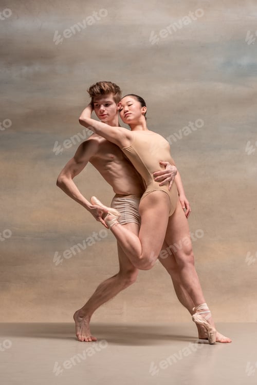 Preview: Couple of ballet dancers posing over gray background