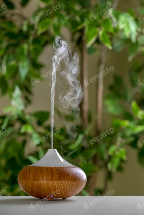 Preview: Aroma oil diffuser lamp on table against blurred background