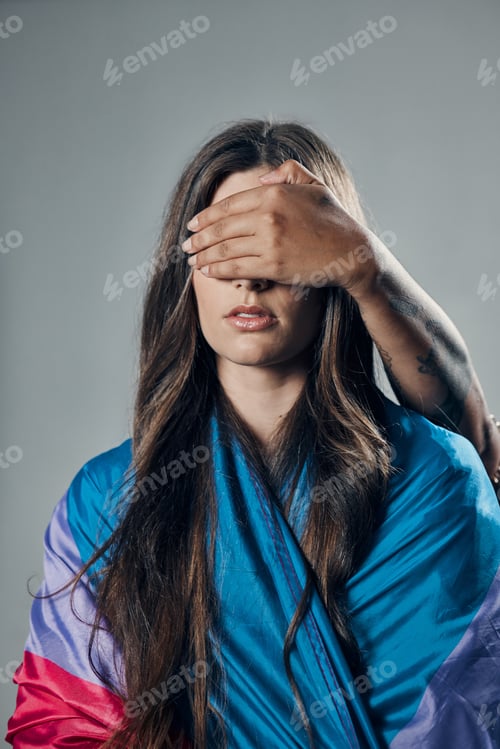 Preview: Surprise, cover and woman with bisexual flag isolated on a grey studio background. Love, freedom an