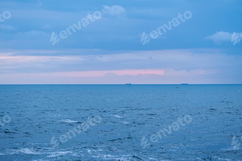 Preview: Sundown seascape. Ocean and cloudy sky.