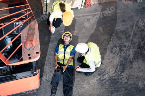 Preview: Asian man worker had accident broken his leg lying near forklift truck on floor in warehouse.