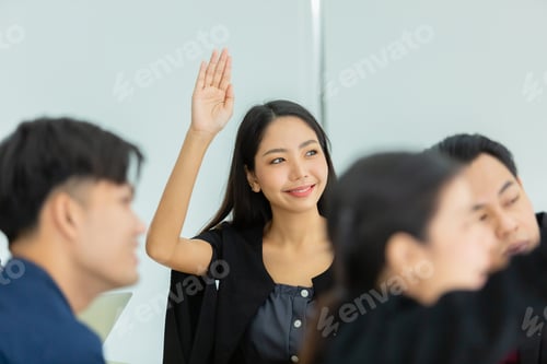 Preview: business person showing hand up for presentation in meeting room seminar training