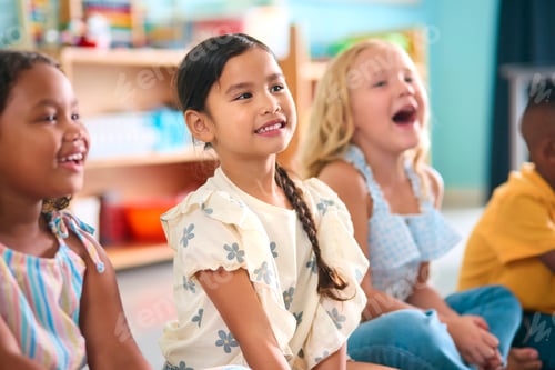 Preview: Line Of Smiling Primary Or Elementary School Students Sitting On Floor During Classroom Lesson