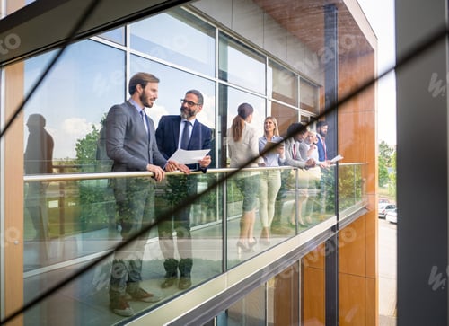 Preview: Successful business people are talking and smiling during the coffee break in office outdoor