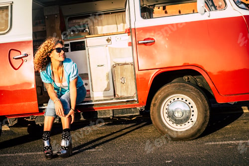 Preview: Attractive young woman enjoy travel with old stylish red van - female pretty people sit down