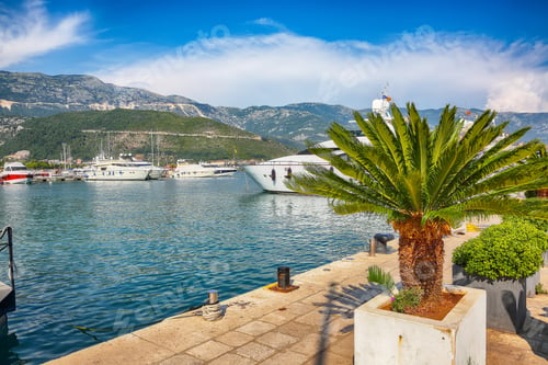 Preview: Captivating View of marine port with boats and yachts moored up in town Budva city