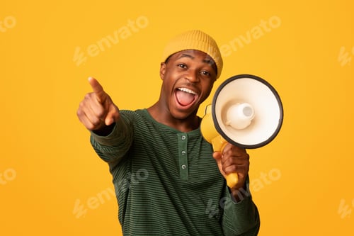 Preview: Cheerful Black Guy Shouting In Loudspeaker And Pointing At Camera