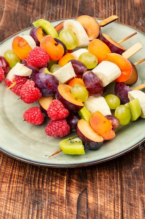 Preview: Delicious Fruit Skewers on Wooden Background