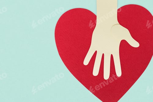 Preview: Paper craft hand with a heart supporting donations during coronavirus pandemic background